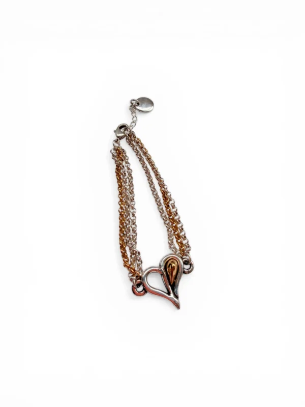 Pulsera bicolor para mujer con diseño de corazón calado, joyería elegante ajustable.